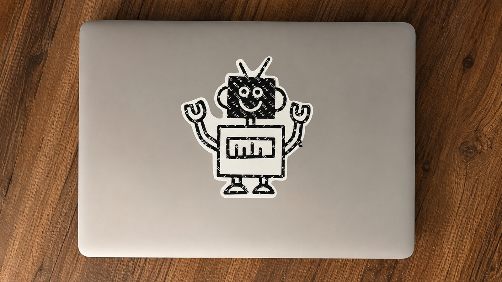 A laptop lid with a single large robot sticker